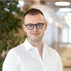 Dawid Aleksander Walczak, senior software engineer, smiling in a white shirt